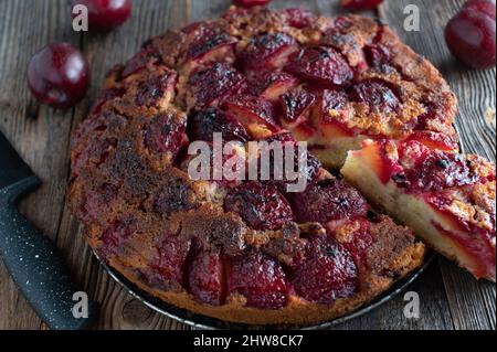 Closeup of a fresh and homemade baked upside down plum cake Stock Photo