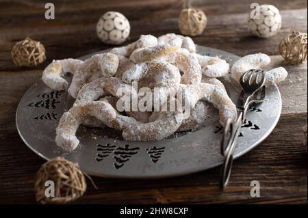 Christmas cookies on a silver plate on wooden table. Traditional german vanillekipferl Stock Photo