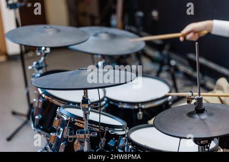 Someone playing a cymbol on a set of drumsat a local church for the praise and worship team or a band Stock Photo