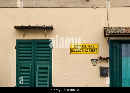 Detail of a sign that says: 'Military Zone - No Entry' on the façade of the custom house in the Old Port, Sanremo, Imperia, Liguria, Italy Stock Photo