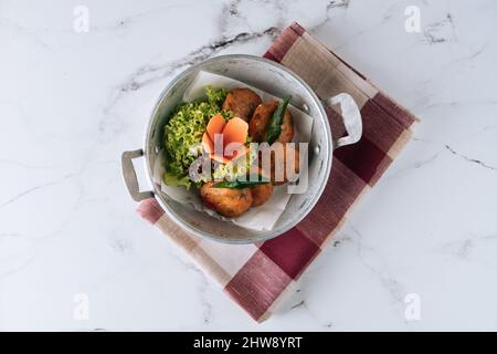 Fried Fish Cake cod fish patties in a dish isolated on mat top view on grey marble background Stock Photo