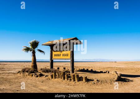 Bombay beach sign at the entrance to the town on the edge of the Salton Sea in Southern California. It is 232 feet below sea level, the second lowest Stock Photo