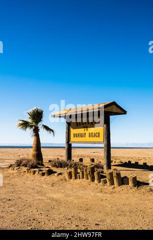 Bombay beach sign at the entrance to the town on the edge of the Salton Sea in Southern California. It is 232 feet below sea level, the second lowest Stock Photo