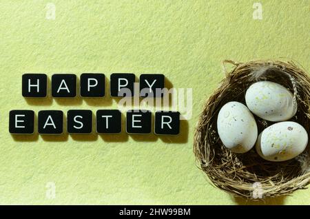 happy easter wishes with nest and eggs Stock Photo