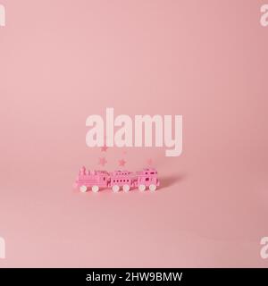Magical pink train with wagons and star smoke on pastel background Stock Photo