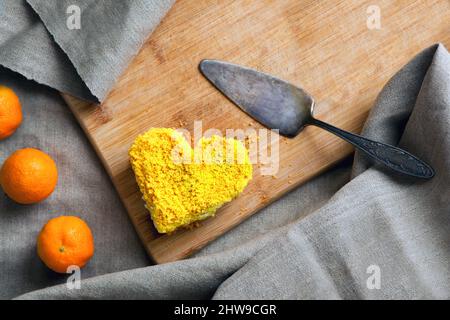 yellow cake heart shaped. Delicate dessert combines juicy tropical aromas of mango and passion fruit Stock Photo