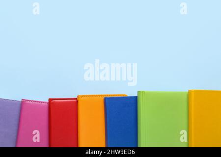 Many different notebooks on color background, closeup Stock Photo