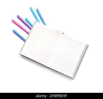 Blank open notebook and felt-tip pens on white background Stock Photo