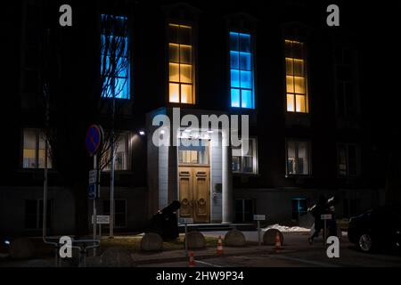 Estonian Ministry of Defence building at night in Ukrainian flag colours. Ministry of Defence Stock Photo