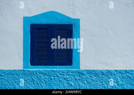 Blue window shutters on house in Spain Stock Photo