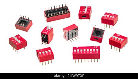 Various DIP switch set for PCB isolated on white background. Group of slide-style or piano-style manual electric switches in red dual in-line package. Stock Photo