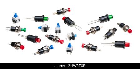 Various miniature push button switches isolated on white panoramic background. Collection of small electronic components. Round on or off pushbuttons. Stock Photo