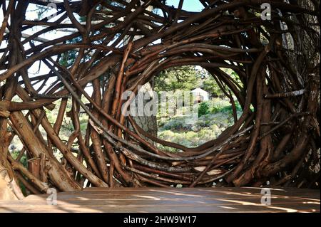 Treebones Twig Hut handmade with woven branches, built by a Big Sur artist, overlooking the vast Pacific Ocean, coastline and Big Sur, California, USA Stock Photo