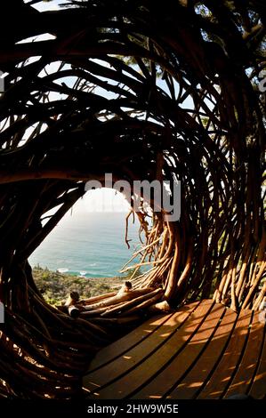 Treebones Twig Hut handmade with woven branches, built by a Big Sur artist, overlooking the vast Pacific Ocean, coastline and Big Sur, California, USA Stock Photo