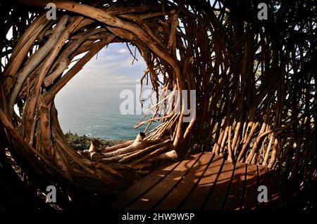 Treebones Twig Hut handmade with woven branches, built by a Big Sur artist, overlooking the vast Pacific Ocean, coastline and Big Sur, California, USA Stock Photo