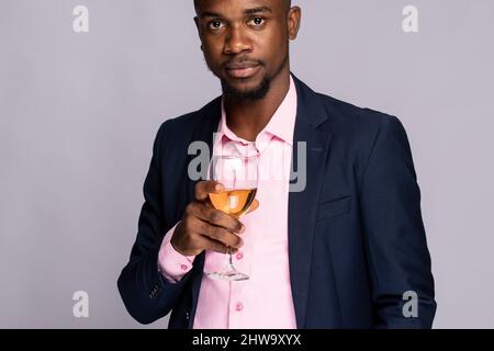 African American male giving a toast with a wine glass Stock Photo