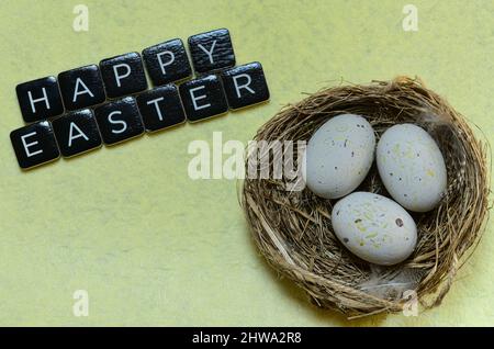 happy easter wishes with nest and eggs Stock Photo