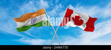 crossed national flags of Canada and India flag waving in the wind at ...
