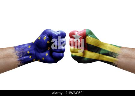 Two hands punch to each others on white background. Country flags painted fists, conflict crisis concept between european union and togo Stock Photo