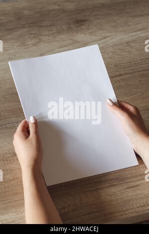 female hands with a sheet of paper Stock Photo