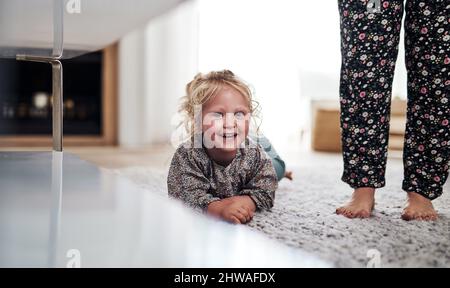 Can you help me convince my mum to join me. Cropped portrait of an adorable little girl bonding with her mother during a day at home. Stock Photo