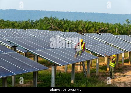 Teamwork electrician installing solar panels working on alternative energy sources clean, Solar Power. Stock Photo