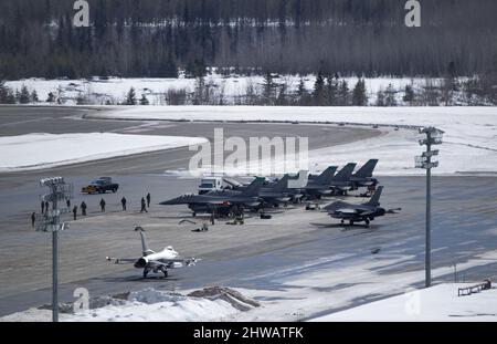 Eight U.S. Air Force F-16 Fighting Falcons, assigned to the 180th Fighter Wing, arrive at Joint Base Elmendorf-Richardson, Alaska, during U.S. Northern Command Exercise ARCTIC EDGE 2022, March 3, 2022. AE22 is a biennial homeland defense exercise to provide high quality and effective joint training in austere cold weather conditions. Additionally, AE22 is the largest joint exercise in Alaska, with approximately 1,000 U.S. military personnel training alongside members of the Canadian Armed Forces. (U.S. Air Force photo by Staff Sgt. Trevor T. McBride) Stock Photo