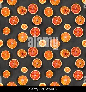 Seamless pattern with red bloody oranges on black stone background. Stock Photo