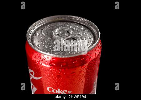 View over a can of Coca-Cola with water droplets isolated on a black background. Close-up. Russia, Krasnodar, December 15, 2021 Stock Photo