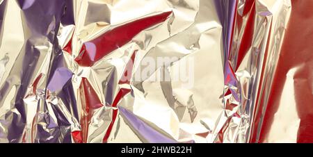 Premium Photo  Close-up of crumpled silver aluminum foil texture in red  tone. abstract background, use for design.