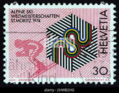 SWITZERLAND - CIRCA 1973: A stamp printed in Switzerland issued for the World Alpine Skiing Championships, St. Moritz 1974, shows skiing emblem. Stock Photo