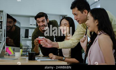 happy business team people working in office looking at monitor computer, cheerful teamwork concept Stock Photo