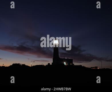 The lighthouse at Headlands, Flamborough Head in the East Riding of Yorkshire with dusk light on clouds. Stock Photo