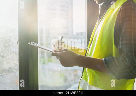 Engineer or inspector checking progressing work in construction site Stock Photo