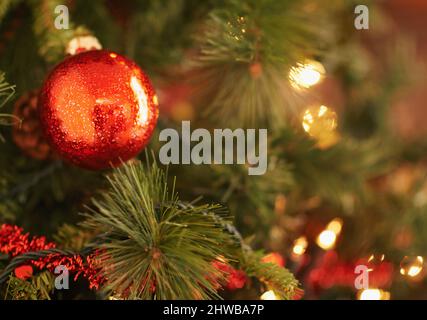 Christmas is love... with all the trimmings. Closeup shot of christmas ornaments on the tree. Stock Photo
