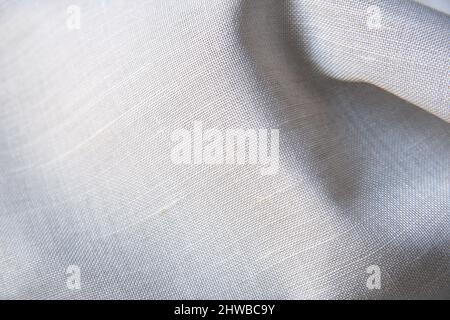 Close up shot of a piece of white wavy cotton cloth with the texture of the fabric in detail Stock Photo