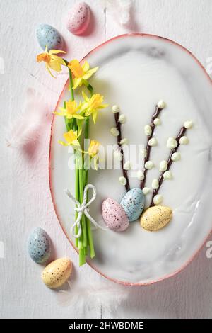 Sweet Easter cake on blue wooden background Easter chocolate cake with eggs. Stock Photo