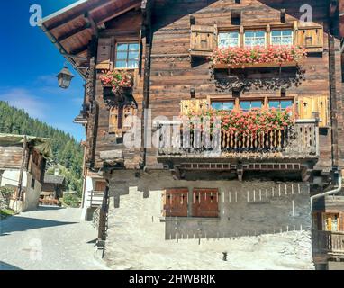 Streets with wooden houses in Grimentz, Switzerland on a sunny day. Stock Photo