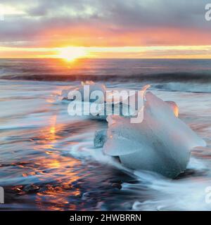 Diamond beach in Vatnajokull, southern Iceland. Sunrise shot of chunks of ice on the black sand, that have been depsited on the beach from the Jokulsa Stock Photo