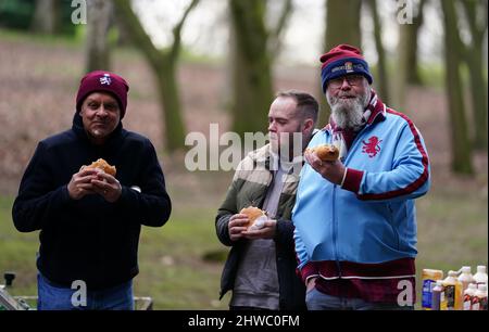 Aston Villa fans grab a bite to eat from a street vendor outside Villa ...