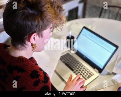 Focus on the face of a female manager of a restaurant doing the accounting Stock Photo