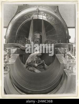 Mechanic in His Shrine: The Heart of the Turbine Power House, Penn. R.R..  Artist: Lewis W. Hine, American, 1874–1940 Stock Photo