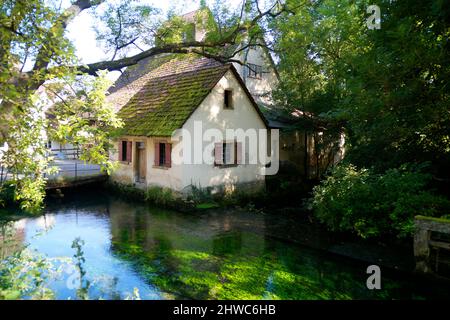 Ancient abandoned house on the the turquois river Blau (Blue) near the pond called Blautopf (Blue Pot) in Blaubeuren (Germany) Stock Photo