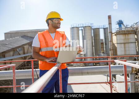 Experienced engineer working hard at heavy industry plant Stock Photo