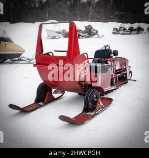 NISSWA, MN - 5 JAN 2022: Antique red Arctic Cat snowmobile, closeup on winter snow in Minnesota. Stock Photo
