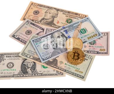 Bitcoin coins at dollar notes pile isolated on white background. Cryptocurrency and cash money concept. High quality photo Stock Photo