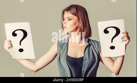 Question mark, symbol. Concept - challenging issue, looking for the answer. Girl question. Woman with doubtful expression and question marks. Thinking Stock Photo