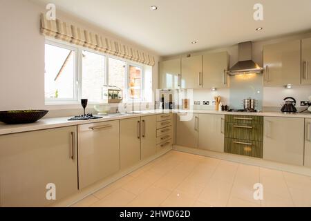 Kitchen in modern showhome, fitted kitchen units, floor and wall cupboards Stock Photo