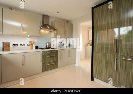 Kitchen in modern showhome, fitted kitchen units, floor and wall cupboards Stock Photo