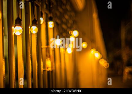 Decor Hanging Yellow Orange Light Lamp With Blurred lamp light Dark Night Background Stock Photo